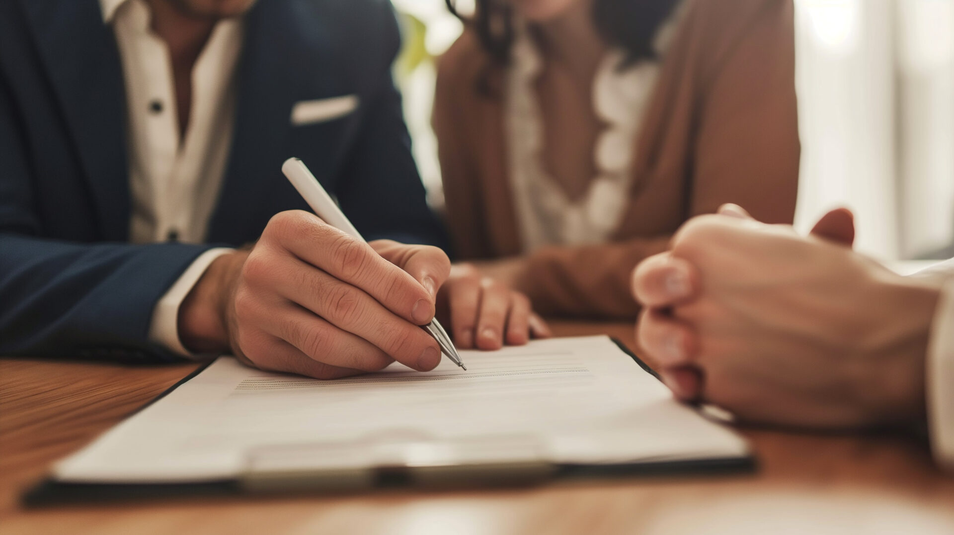 Close up of a couple signing a document together.