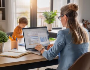 Firefly behind view of working mother attorney working from home with child playing 50811