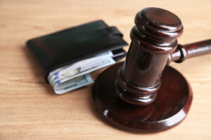 Gavel,And,Money,In,Wallet,On,Wooden,Background